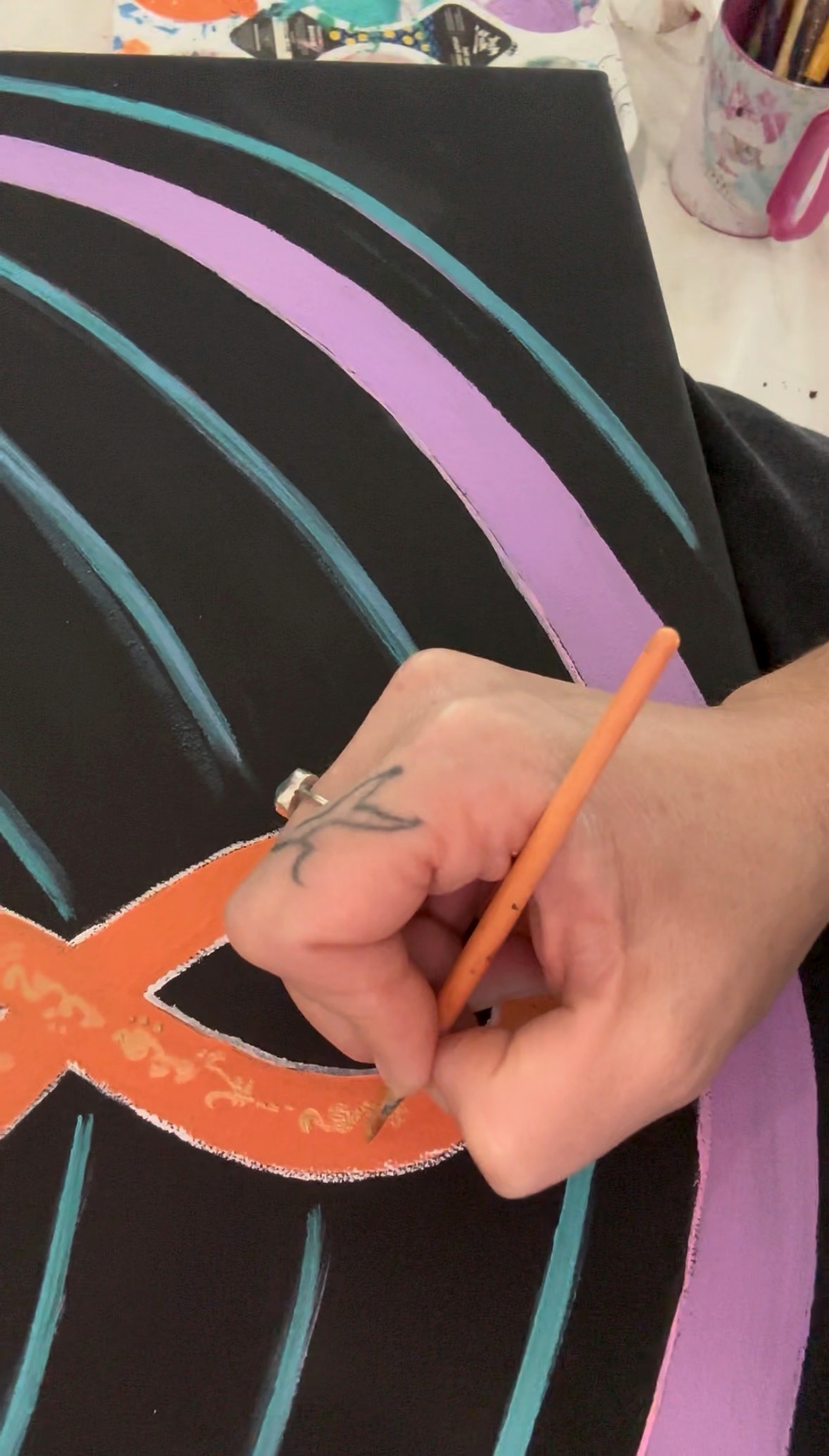 Close detail of Natalie hand-painting a Lightcode canvas