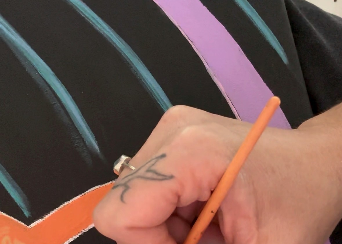 Close detail of Natalie Merino translating a Lightcode into paint by hand